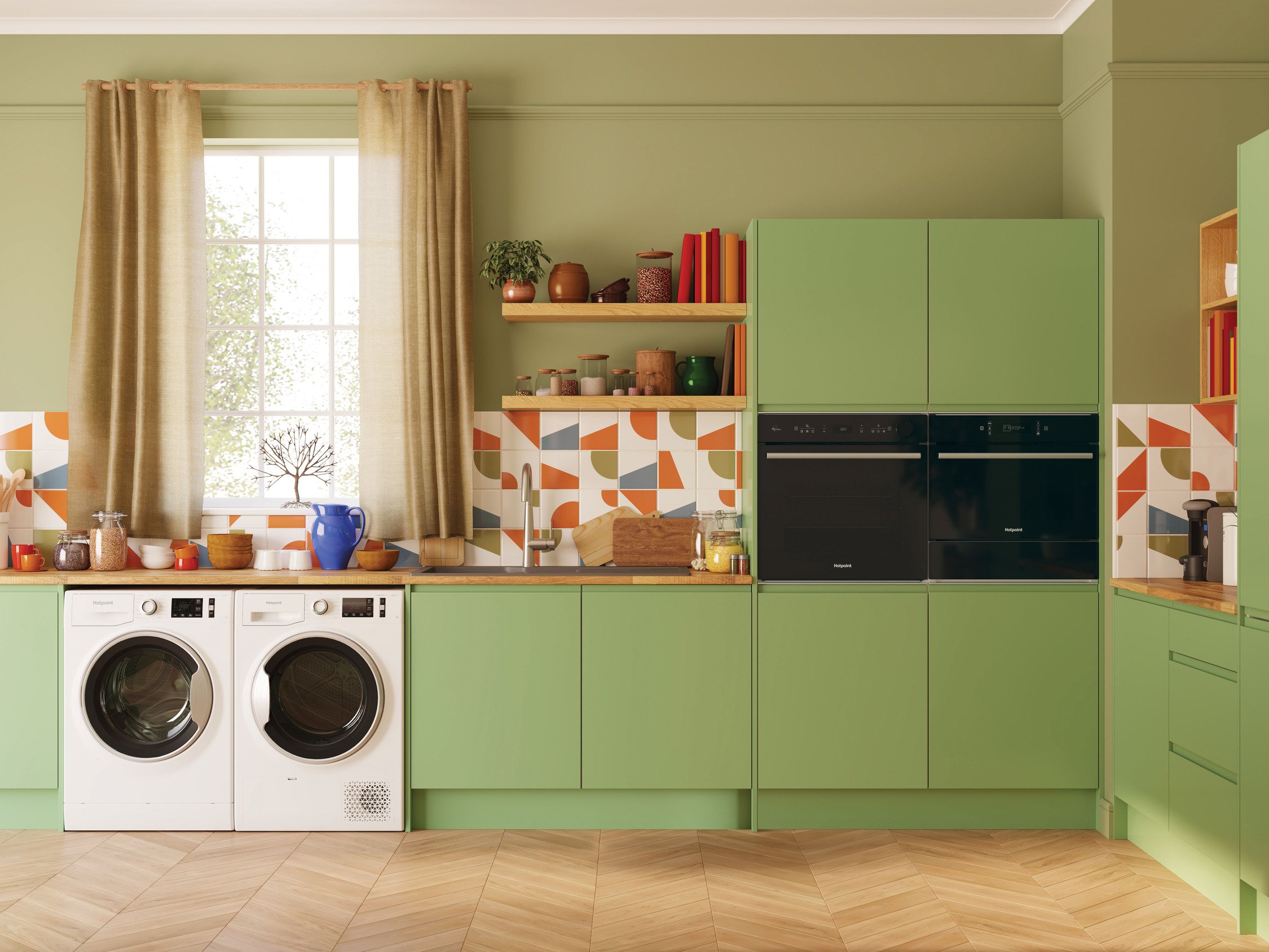 Modern kitchen with green walls, wooden floor, and open shelving, featuring appliances and colorful accents.