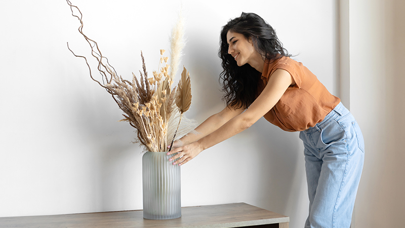 Vrouw laat zien hoe je droge bloemen schikt
