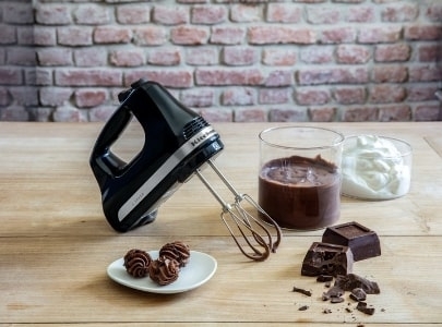 Black hand mixer making chocolate bites