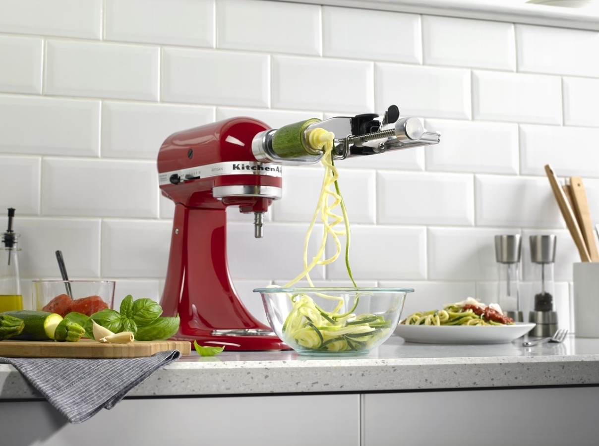 Red mixer making spaghetti of courgette with spiralizer