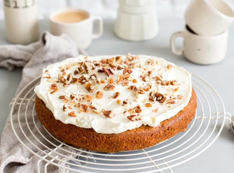 Carrot cake with frosting and walnuts
