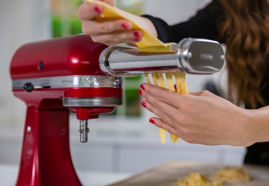 Red mixer with pasta sheet roller attachment