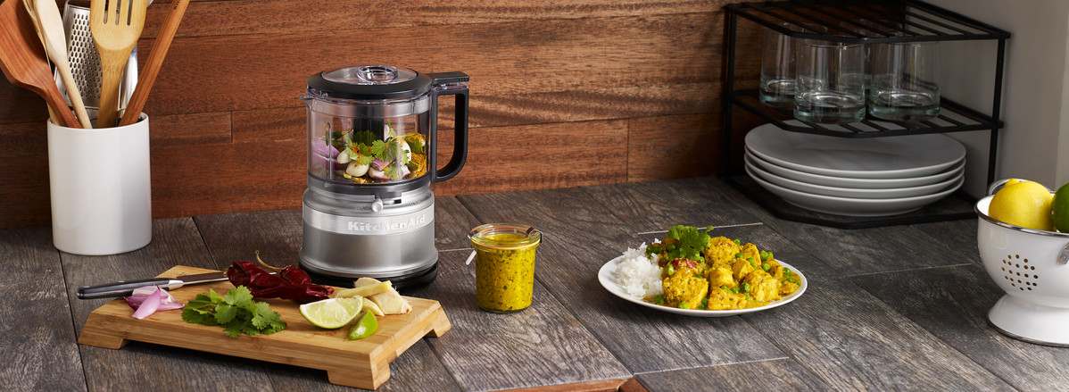 Grey mini food chopper mixing curry sauce
