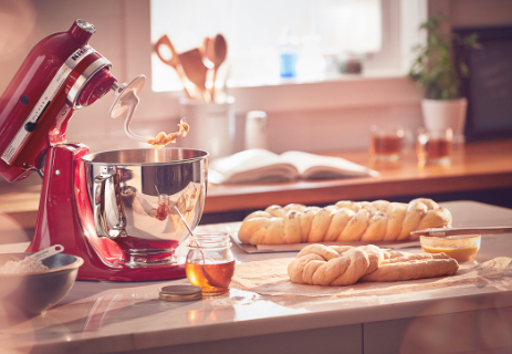 Red mixer and dough hook with fresh bread made