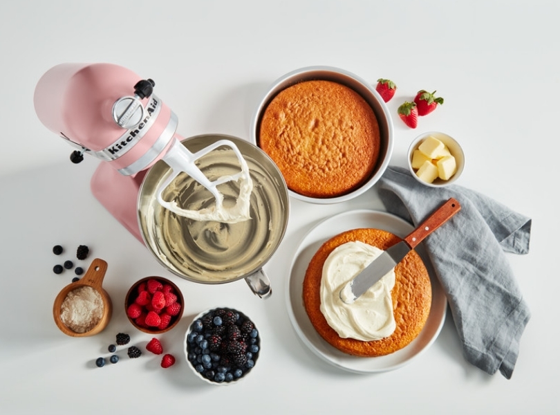 Pink mixer preparing cake with red fruits