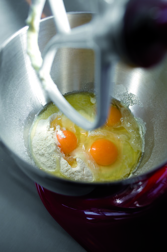 Eggs and flour in a mixing bowl with a paddle attachment