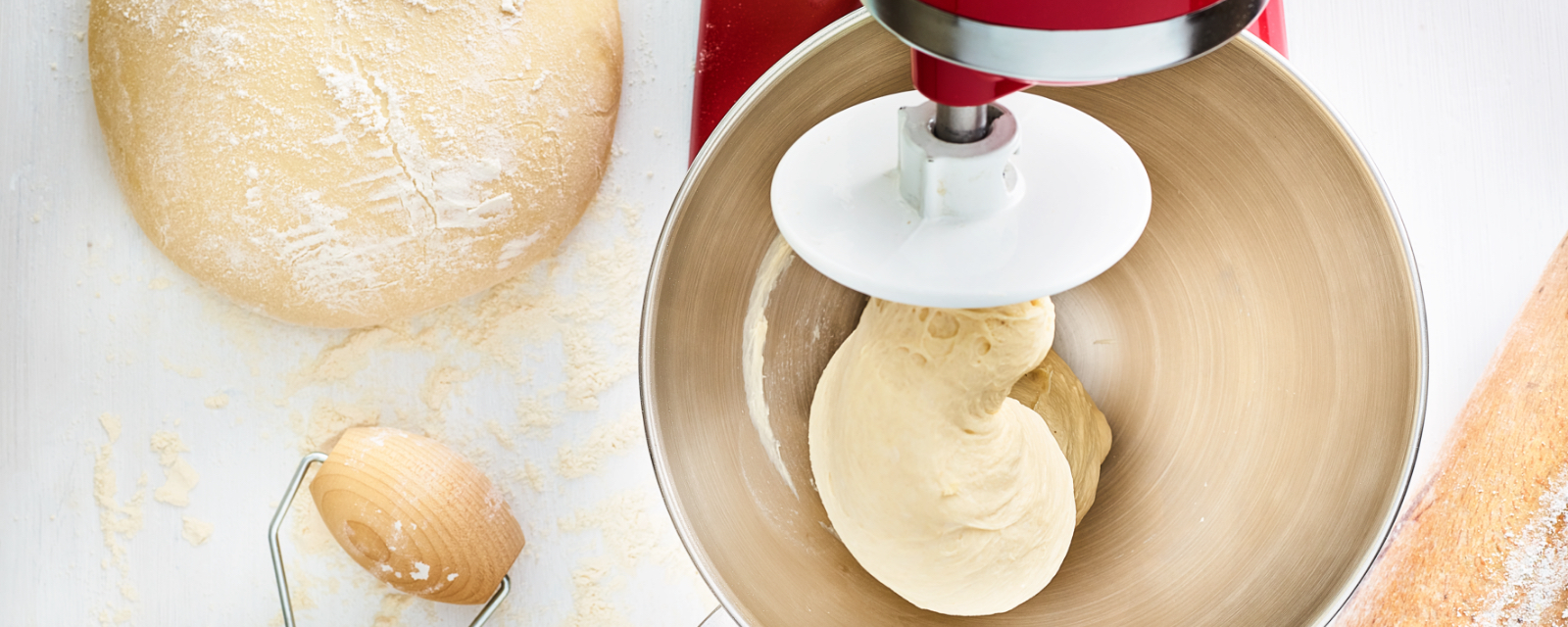 Red mixer kneading dough to make yeast bread