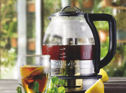 Glass kettle with cup of tea