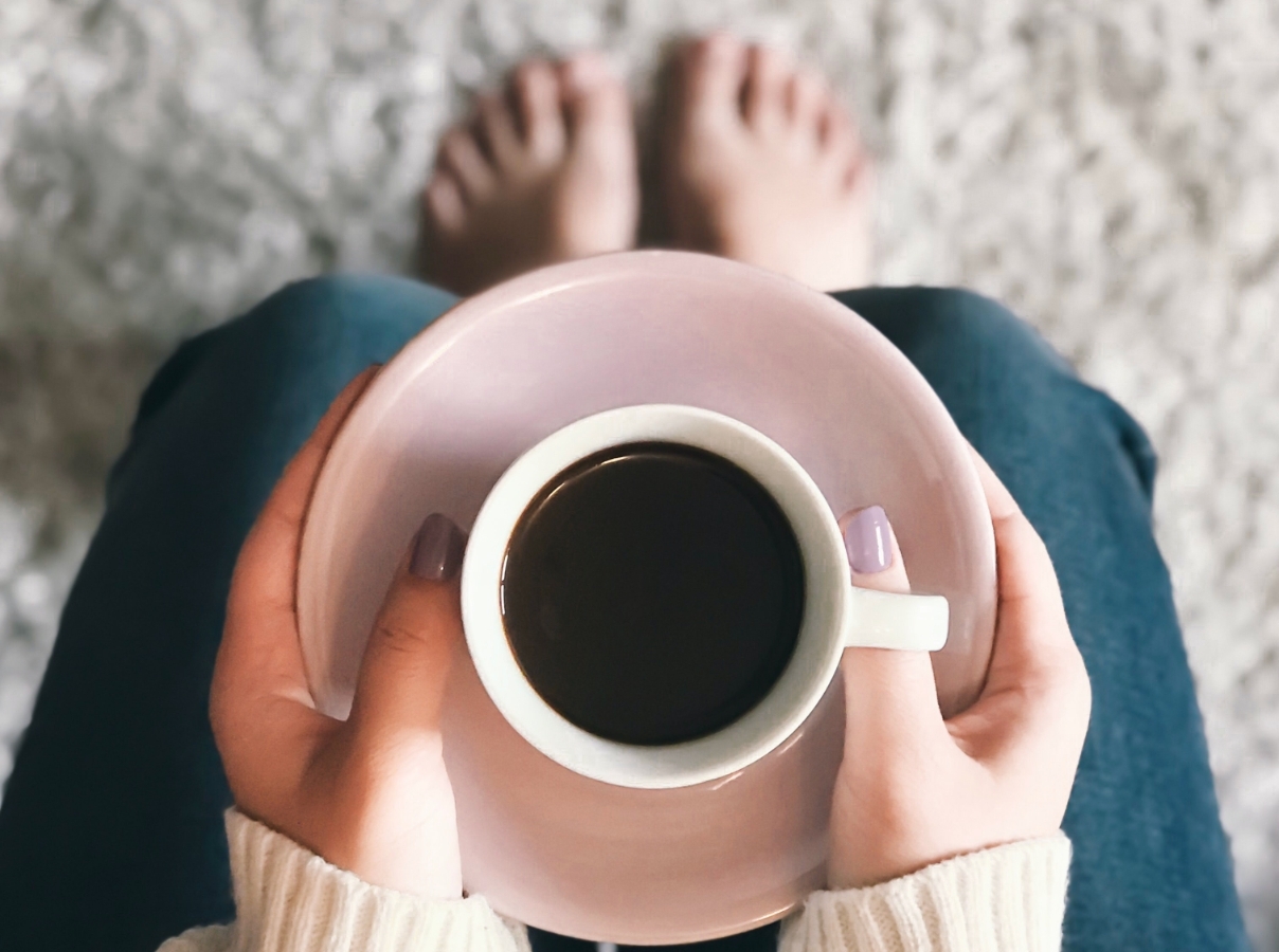 Women with a cup of black coffee