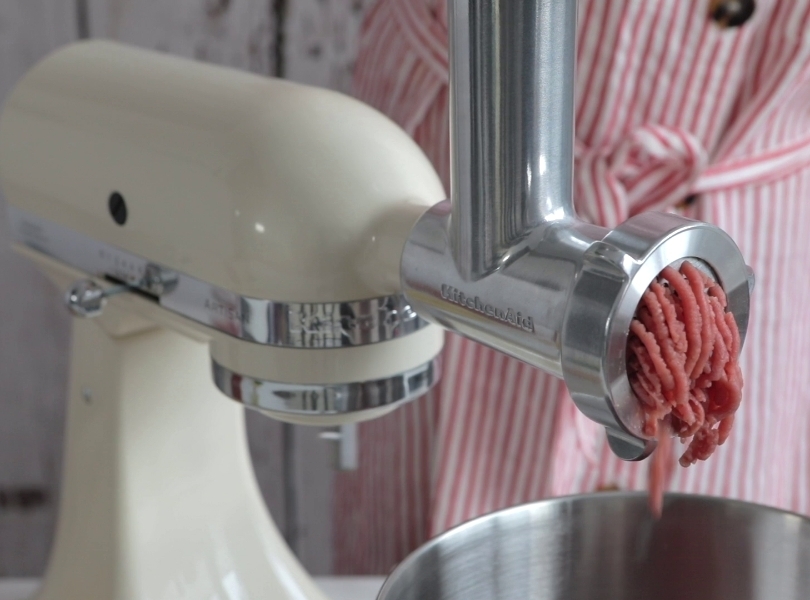 Meat grinder on cream mixer grinding meat