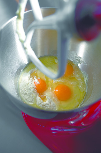 Eggs and flour in a mixing bowl with a paddle attachment