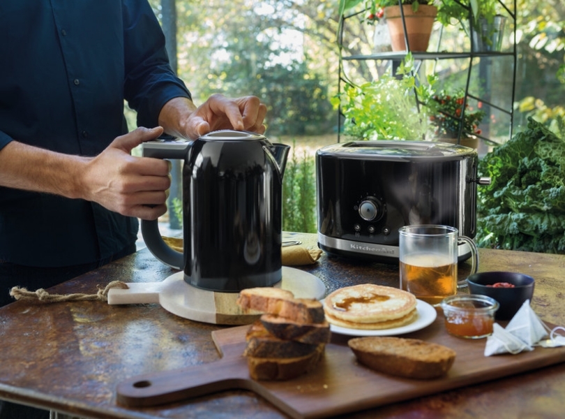 Preparing meal with black variable temperature kettle and toaster set