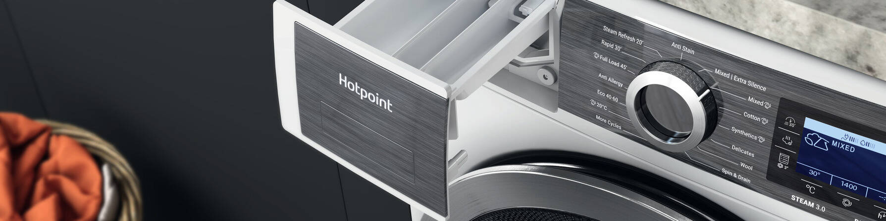 Open detergent drawer of a silver Hotpoint washing machine with a digital display.