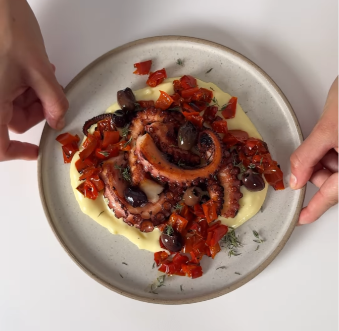 Polpo cotto al vapore con peperoni corno arrosto, olive capperi e maggiorana